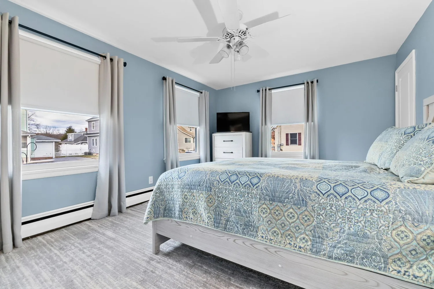 a bedroom with a large bed and a chandelier