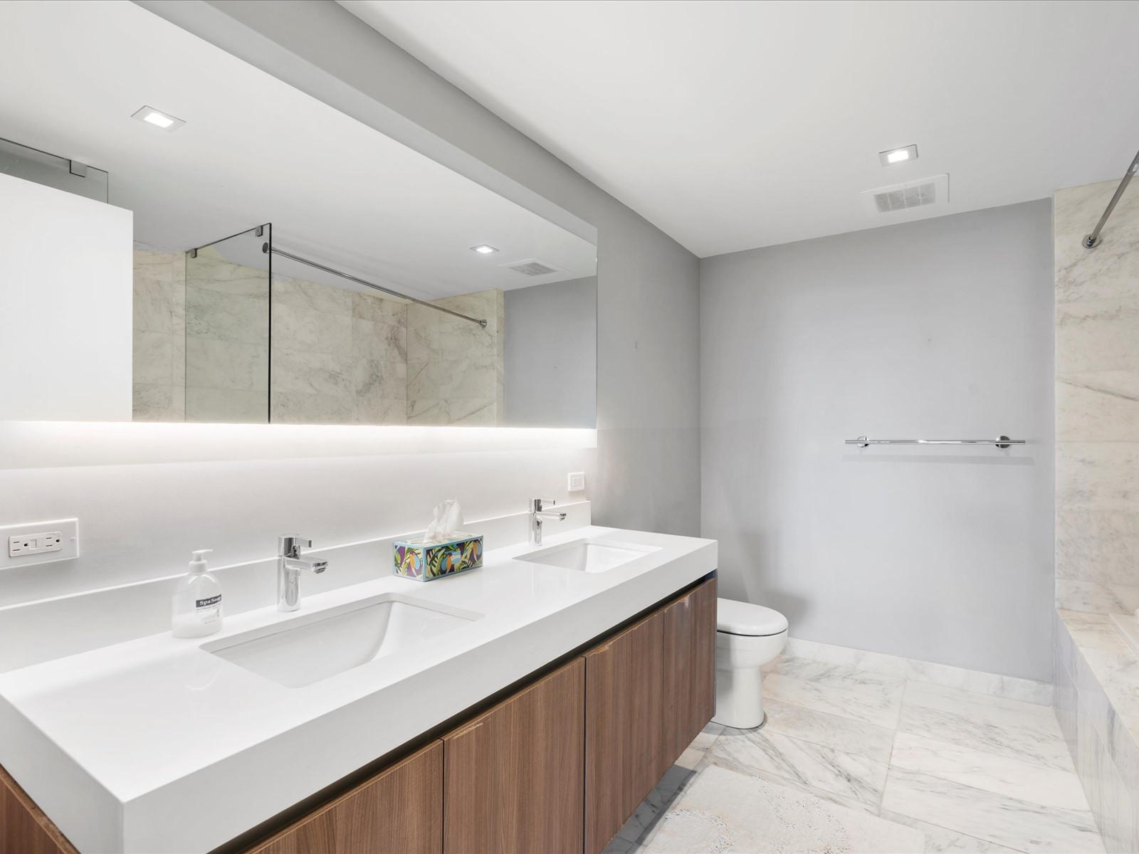 401 North Birch Road, Unit 603 Fort Lauderdale, FL 33304 - Photo 11 of 16 a bathroom with a sink a toilet and a mirror