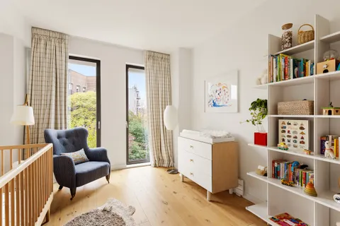 a bedroom with furniture and a book shelf