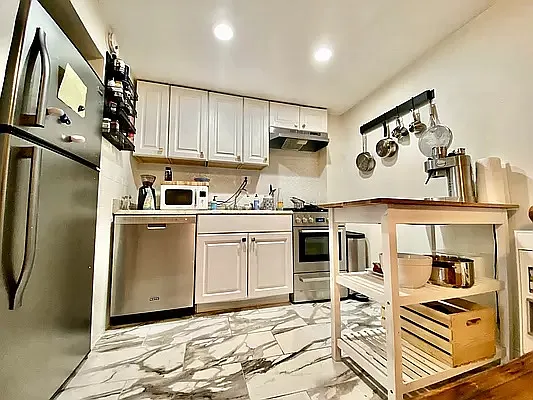 195 Atlantic Avenue, Unit 1 Brooklyn, NY 11201 - Photo 4 of 10 a kitchen with stainless steel appliances granite countertop a stove a sink and a refrigerator
