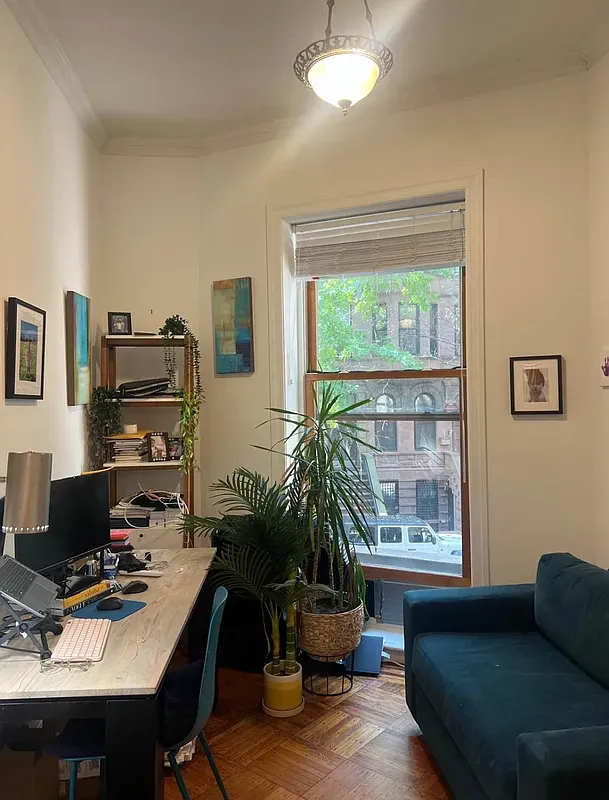 a livingroom with workspace and a window