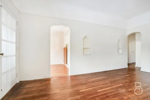 a view of a room with wooden floor