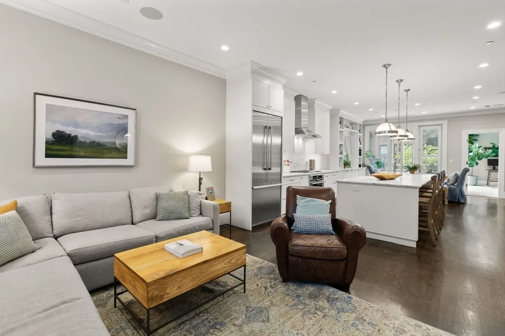 a living room with furniture and kitchen view