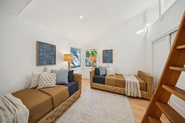 a bedroom with furniture and wooden floor