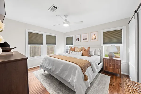 a bedroom with a large bed and a window