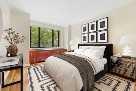 a bed sitting in a bedroom next to a window