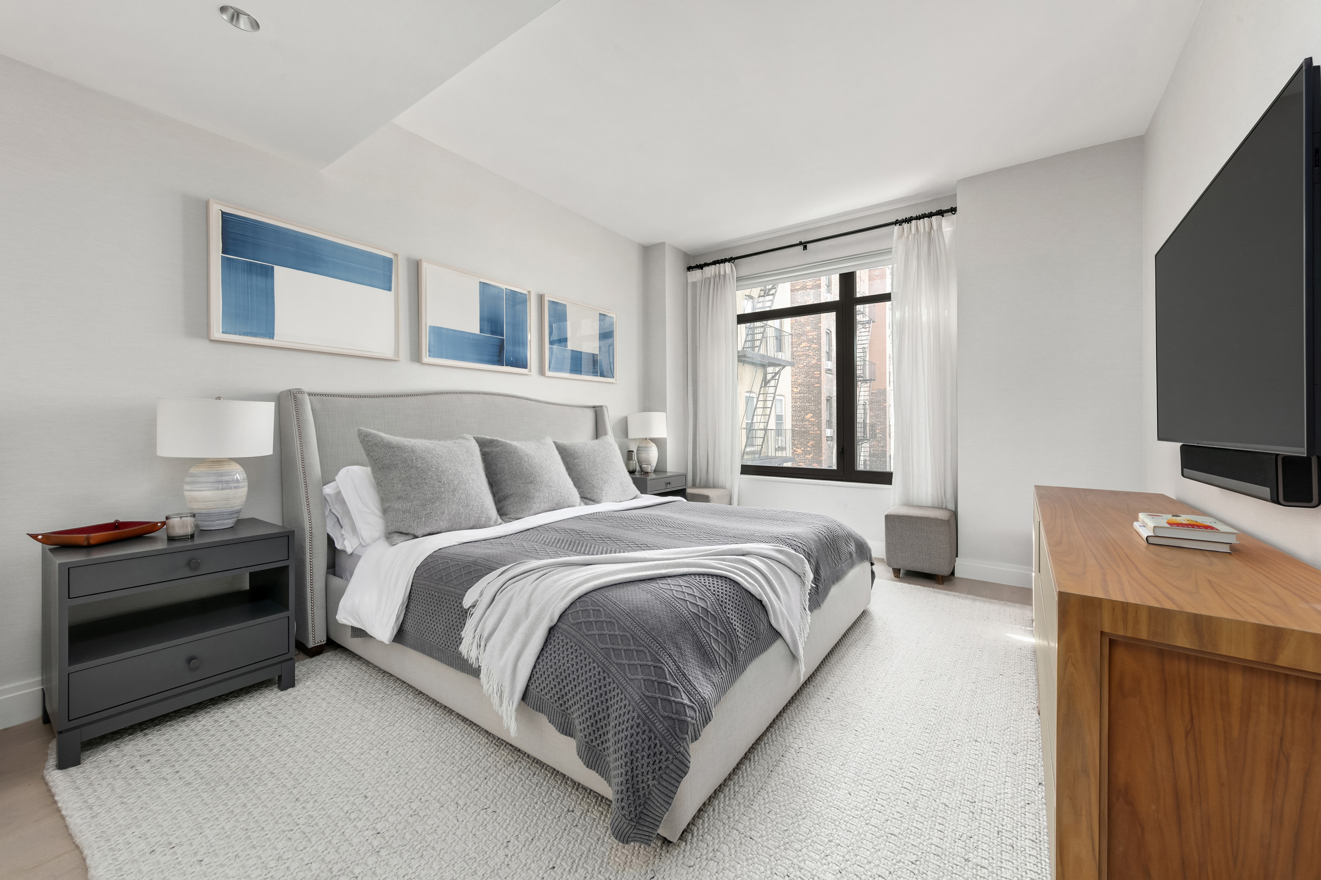 212 West 95th Street, Unit 4B Manhattan, NY 10025 - Photo 5 of 13 a bedroom with a bed and a flat screen tv