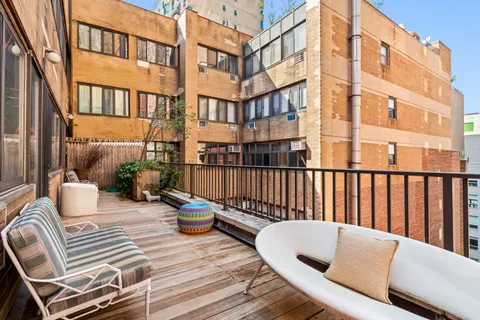 a balcony with table and chairs