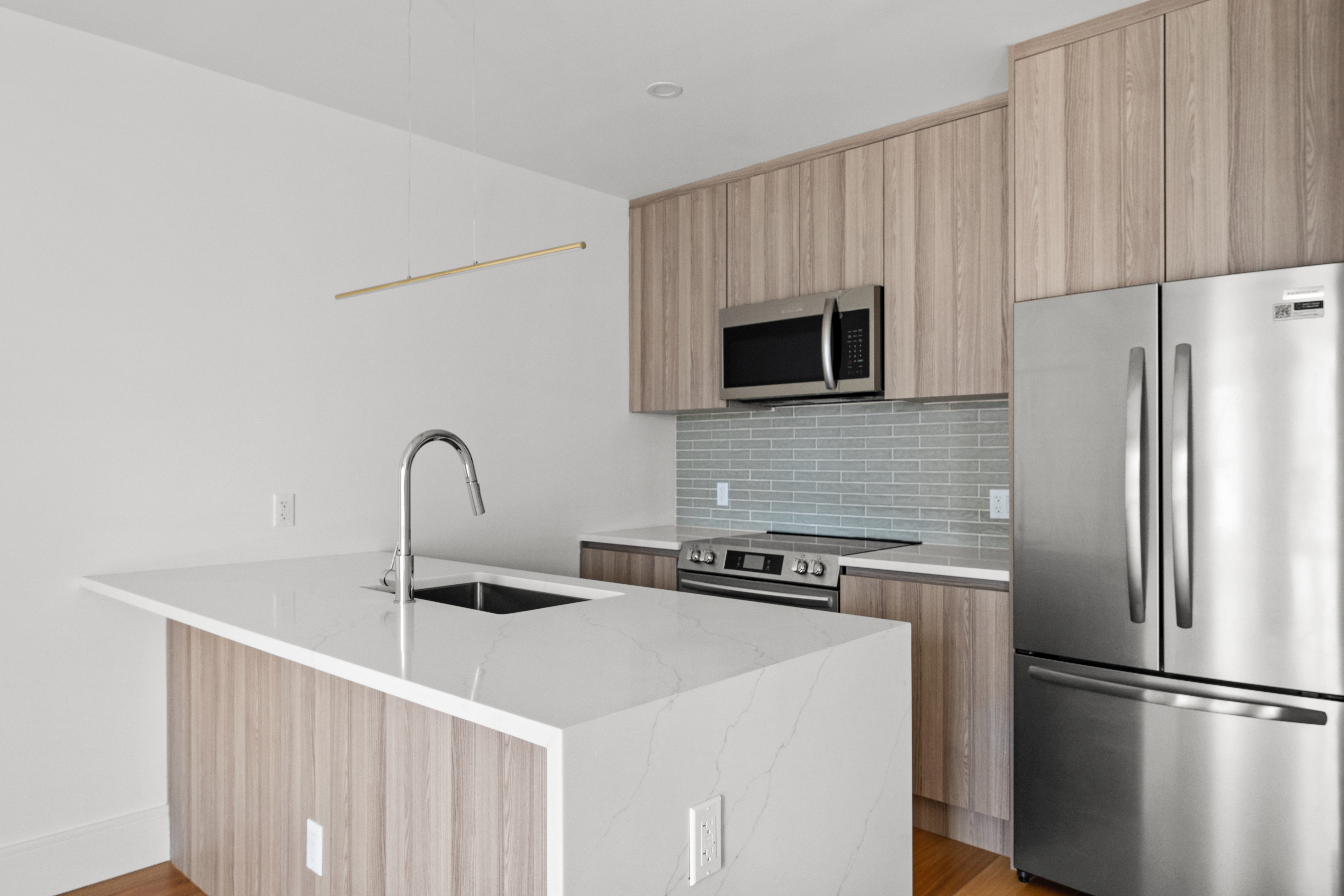 82 Cooper Street, Unit 2B Brooklyn, NY 11207 - Photo 5 of 17 a kitchen with appliances a sink and cabinets