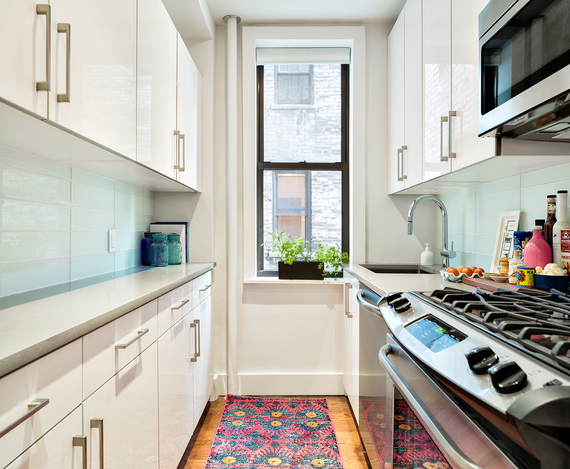245 West 25th Street, Unit 3K Manhattan, NY 10001 - Photo 4 of 14 a kitchen with white cabinets and appliances