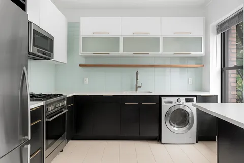 a kitchen with stainless steel appliances granite countertop a stove and a microwave