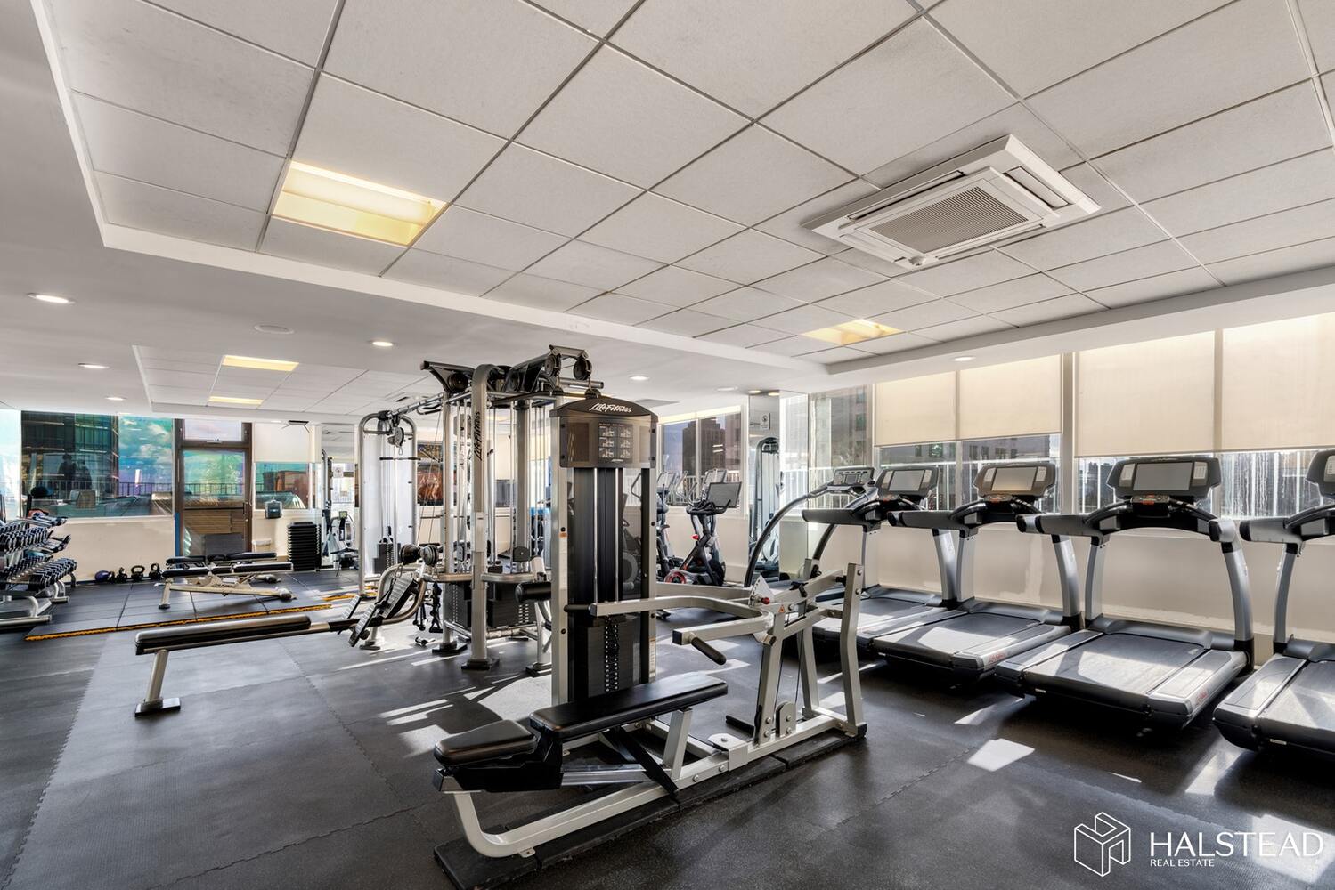 220 East 65th Street, Unit 3K Manhattan, NY 10065 - Photo 9 of 13 a view of a room with gym equipment