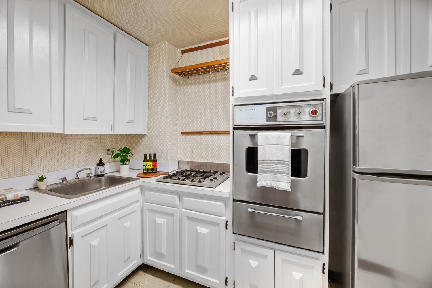 a kitchen with white cabinets and white appliances