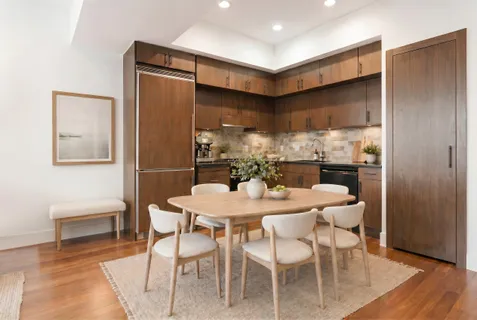 a dining room with furniture and wooden floor