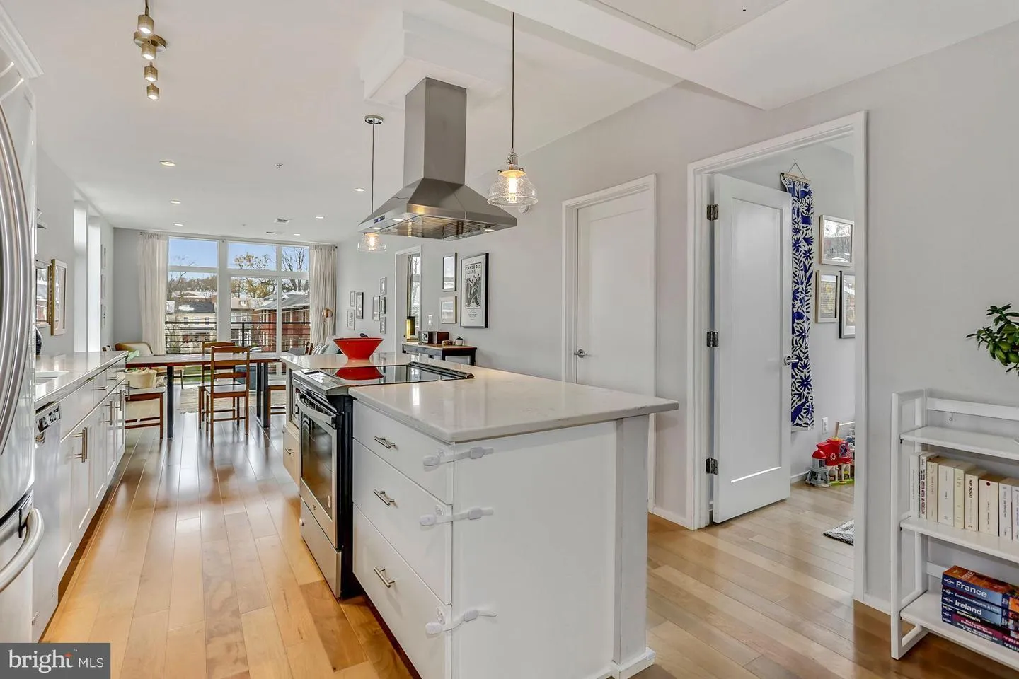 a kitchen with stainless steel appliances granite countertop a sink a stove and a refrigerator