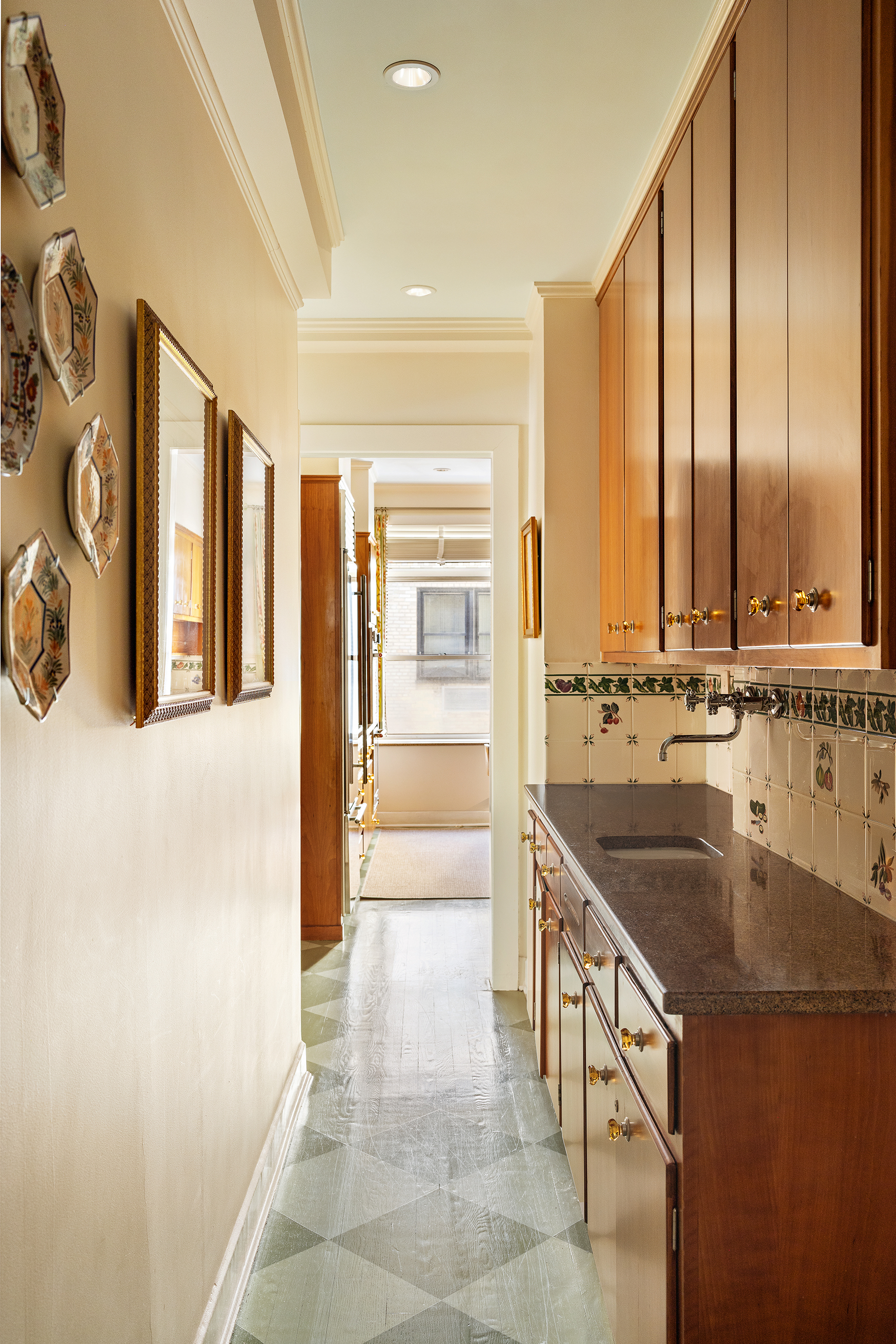 70 East 77th Street, Unit 6A Manhattan, NY 10075 - Photo 8 of 17 a kitchen with stainless steel appliances granite countertop a sink and a refrigerator