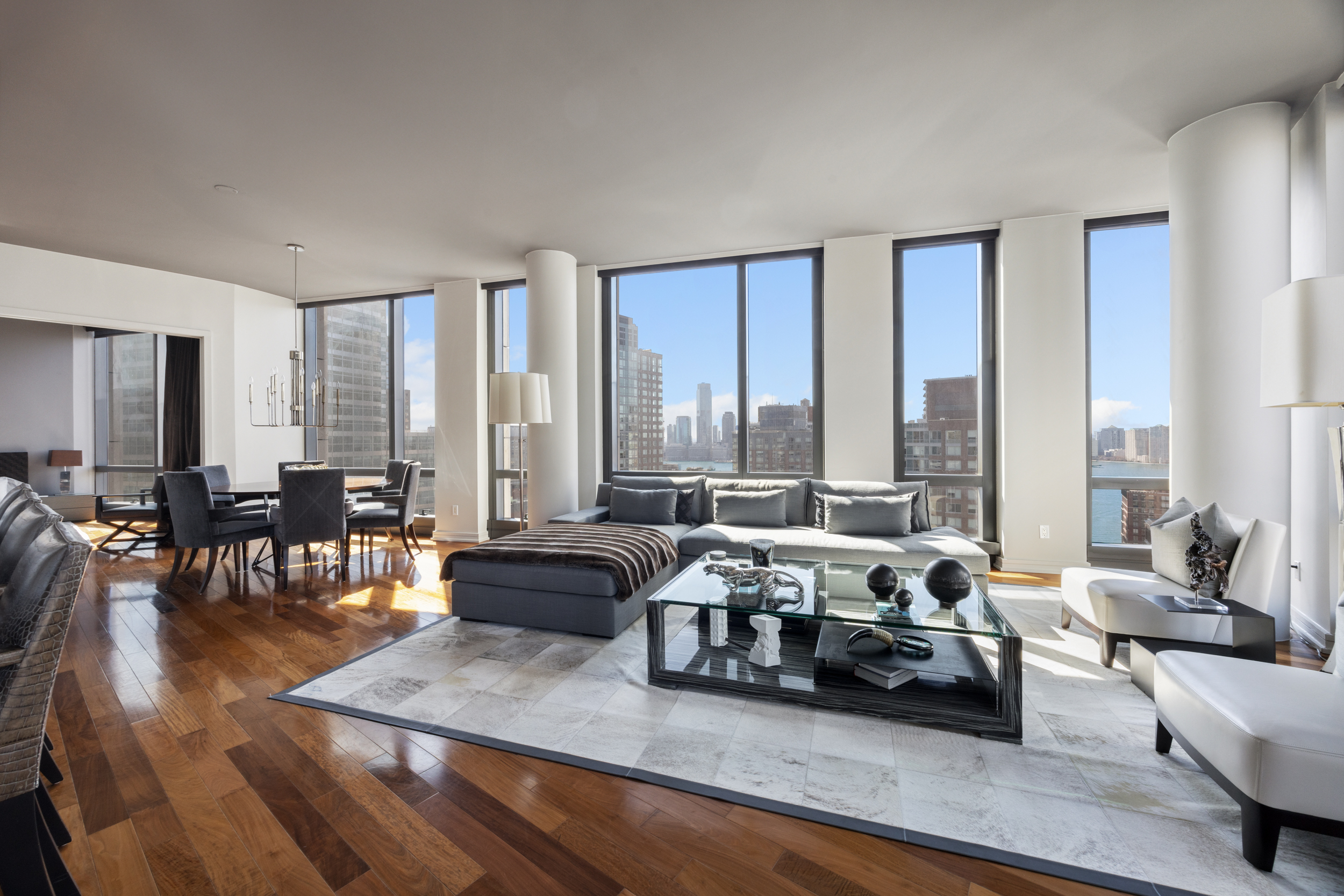 a living room with furniture and large windows