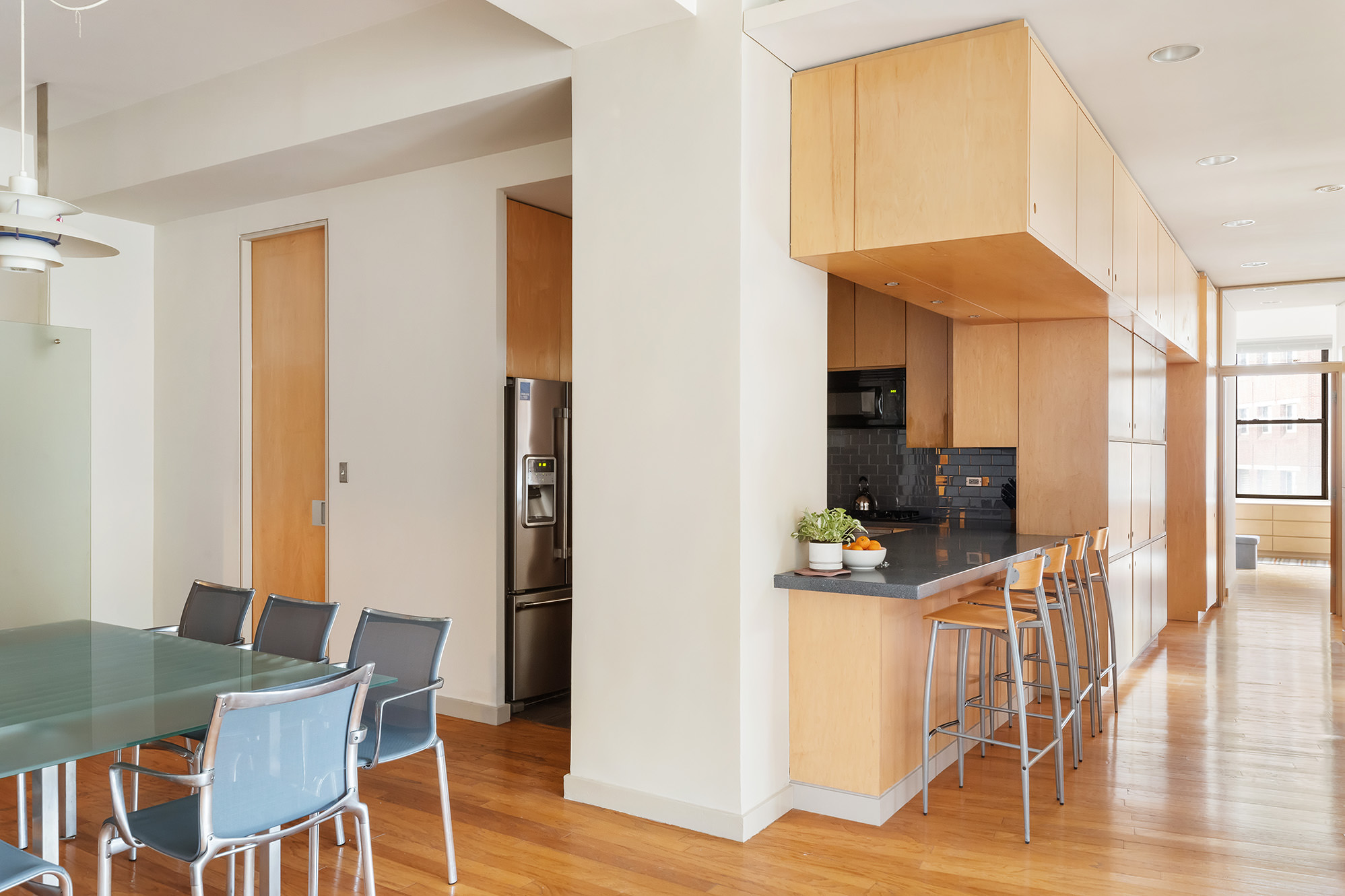 3 Hanover Square, Unit 14EF Manhattan, NY 10004 - Photo 3 of 14 a workspace with furniture and wooden floor