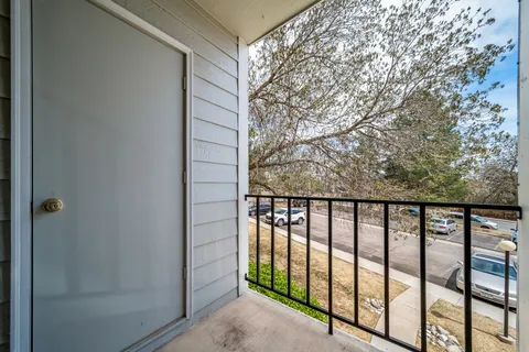 a view of a balcony with wooden floor