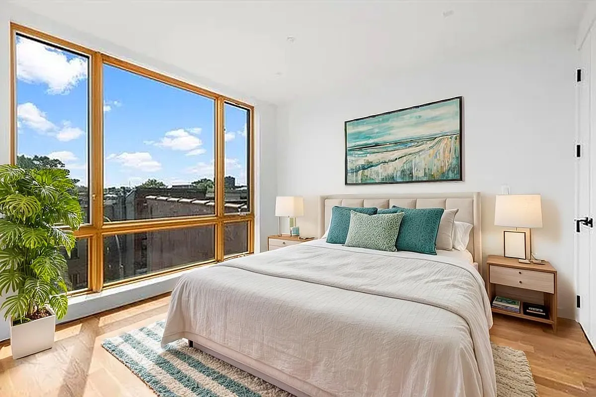 212 Malcolm X Boulevard, Unit 4B Brooklyn, NY 11221 - Photo 3 of 5 a bedroom with a large bed and a large window with outer view