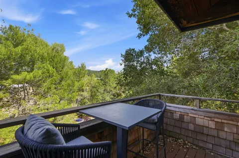 a view of a balcony with furniture