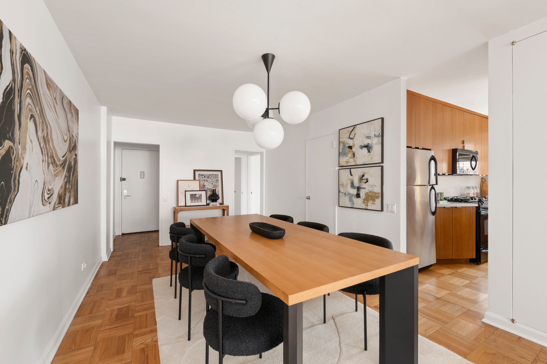 70 East 10th Street, Unit 15R Manhattan, NY 10003 - Photo 6 of 12 a view of a dining room with furniture and wooden floor
