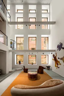 a living room with furniture chess board and a window