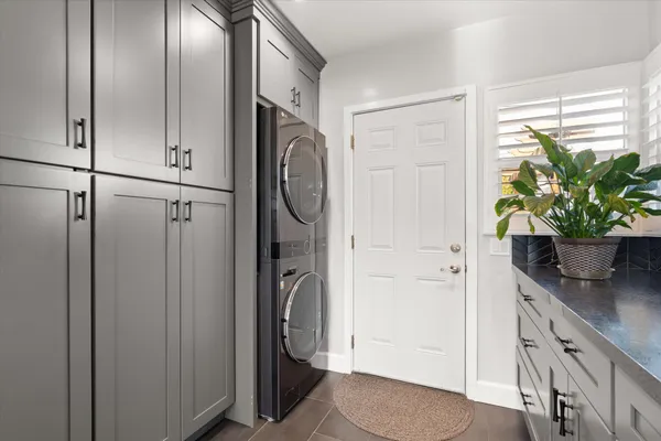 a backyard of a house with a garden and outdoor seating