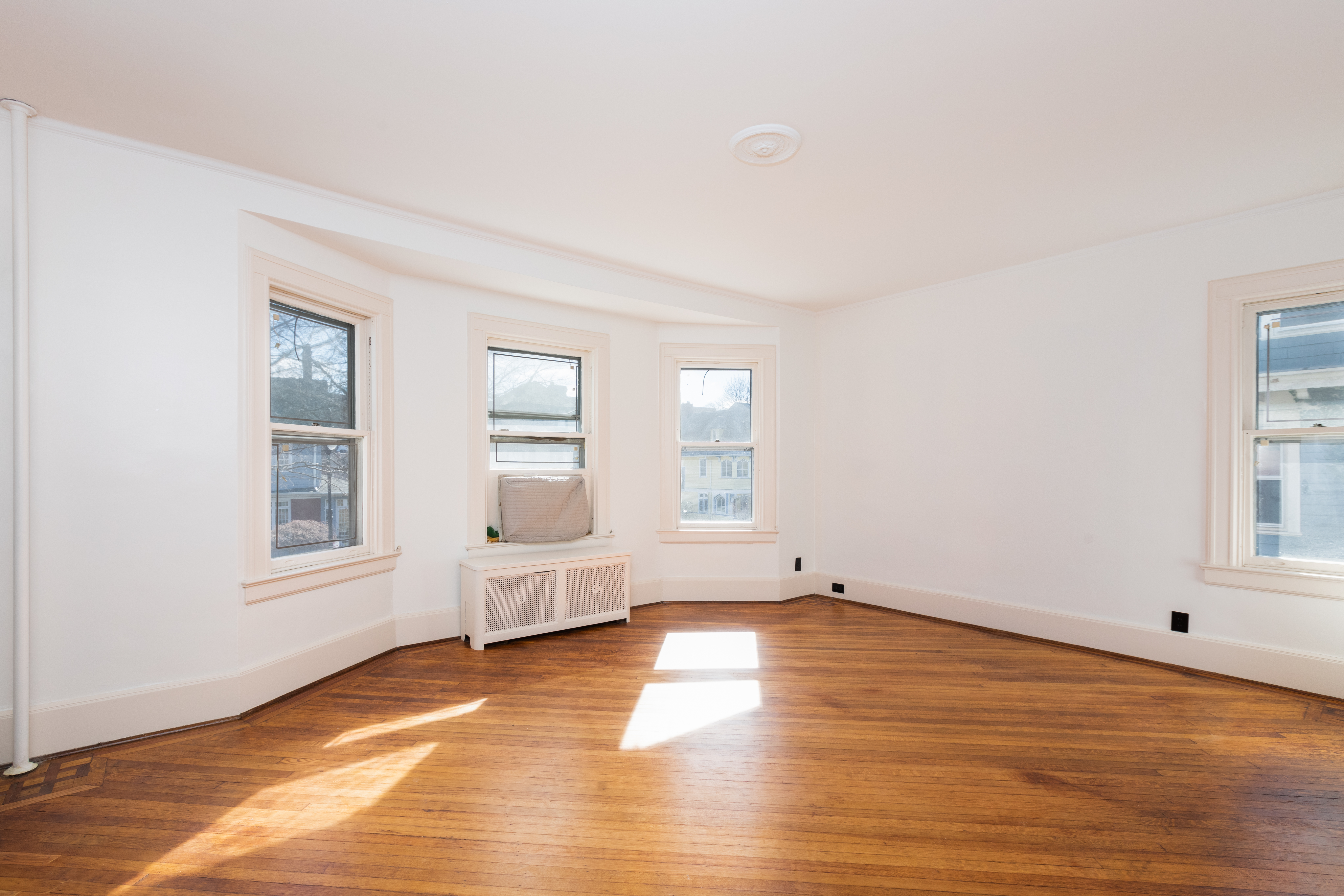 196 Marlborough Road Brooklyn, NY 11226 - Photo 15 of 23 a view of empty room with wooden floor and fan
