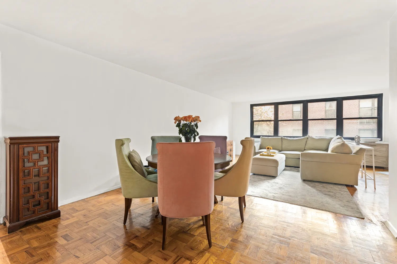 a dining room with furniture and a potted plant