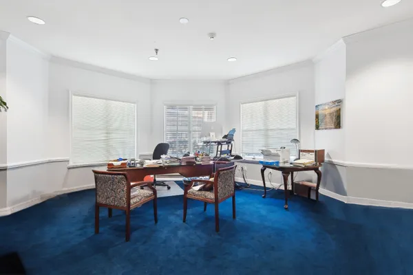 a view of workspace with wooden floor and windows