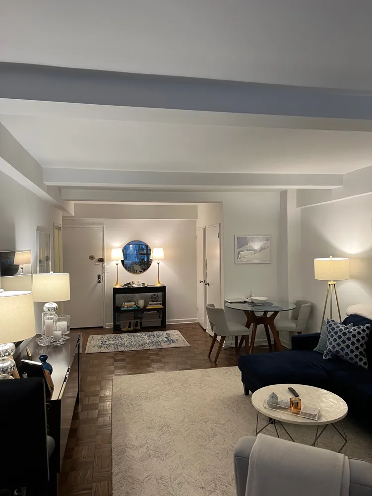 a living room with furniture and a lamp