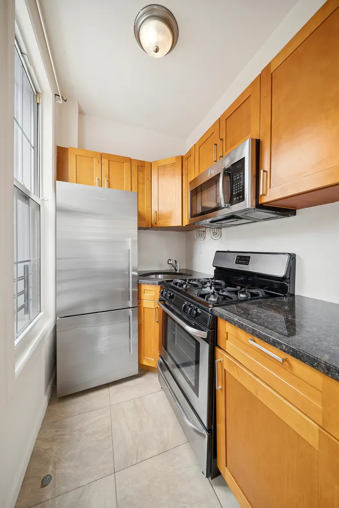 a kitchen with stainless steel appliances granite countertop a stove and a refrigerator