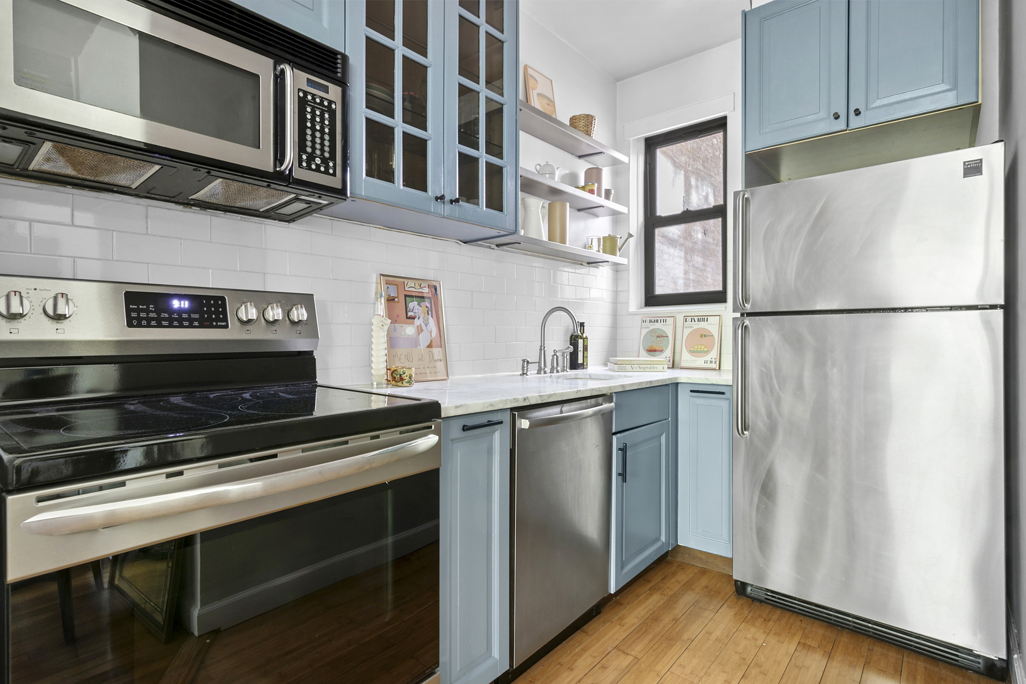 338 Prospect Place, Unit 2B Brooklyn, NY 11238 - Photo 3 of 7 a kitchen with stainless steel appliances a refrigerator a stove and a refrigerator