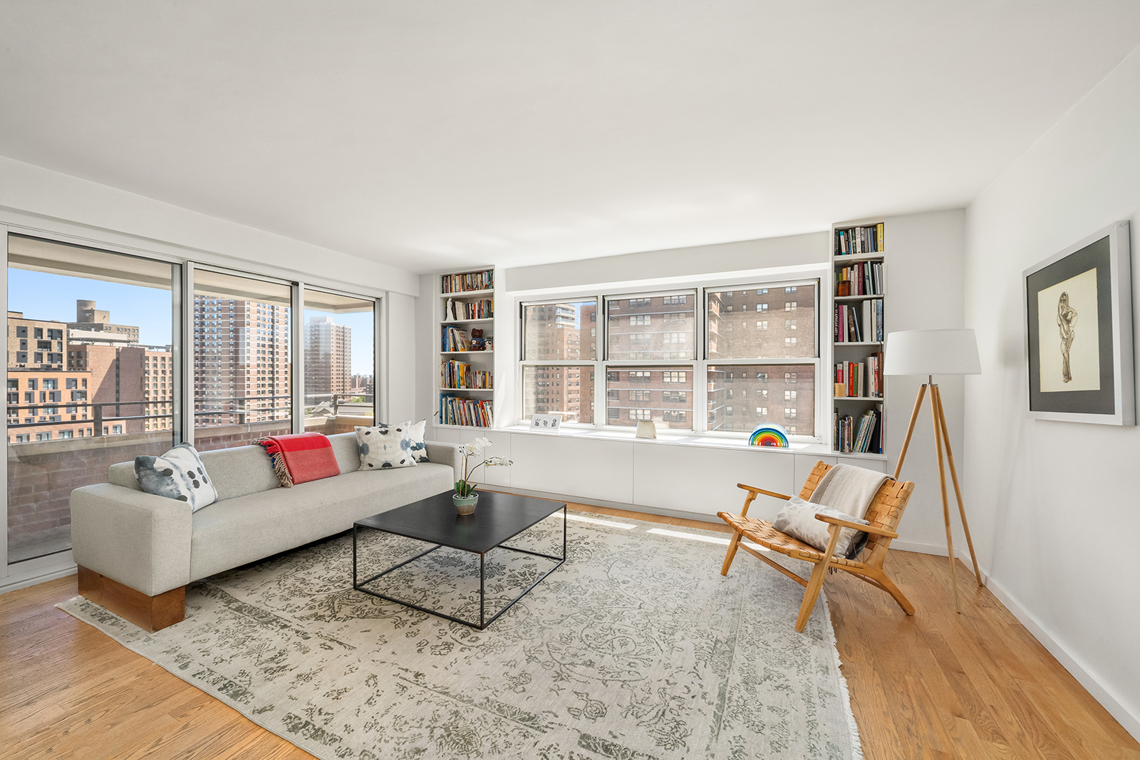 383 Grand Street, Unit M1304 Manhattan, NY 10002 - Photo 1 of 9 a living room with furniture and a large window
