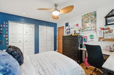 a bedroom with a bed and wooden floor