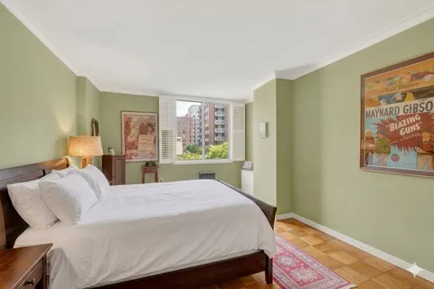a bed room with a bed and cupboard