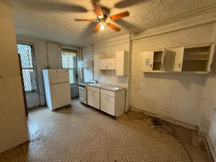 a room with a stove a washer and dryer
