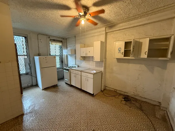 a room with a stove a washer and dryer