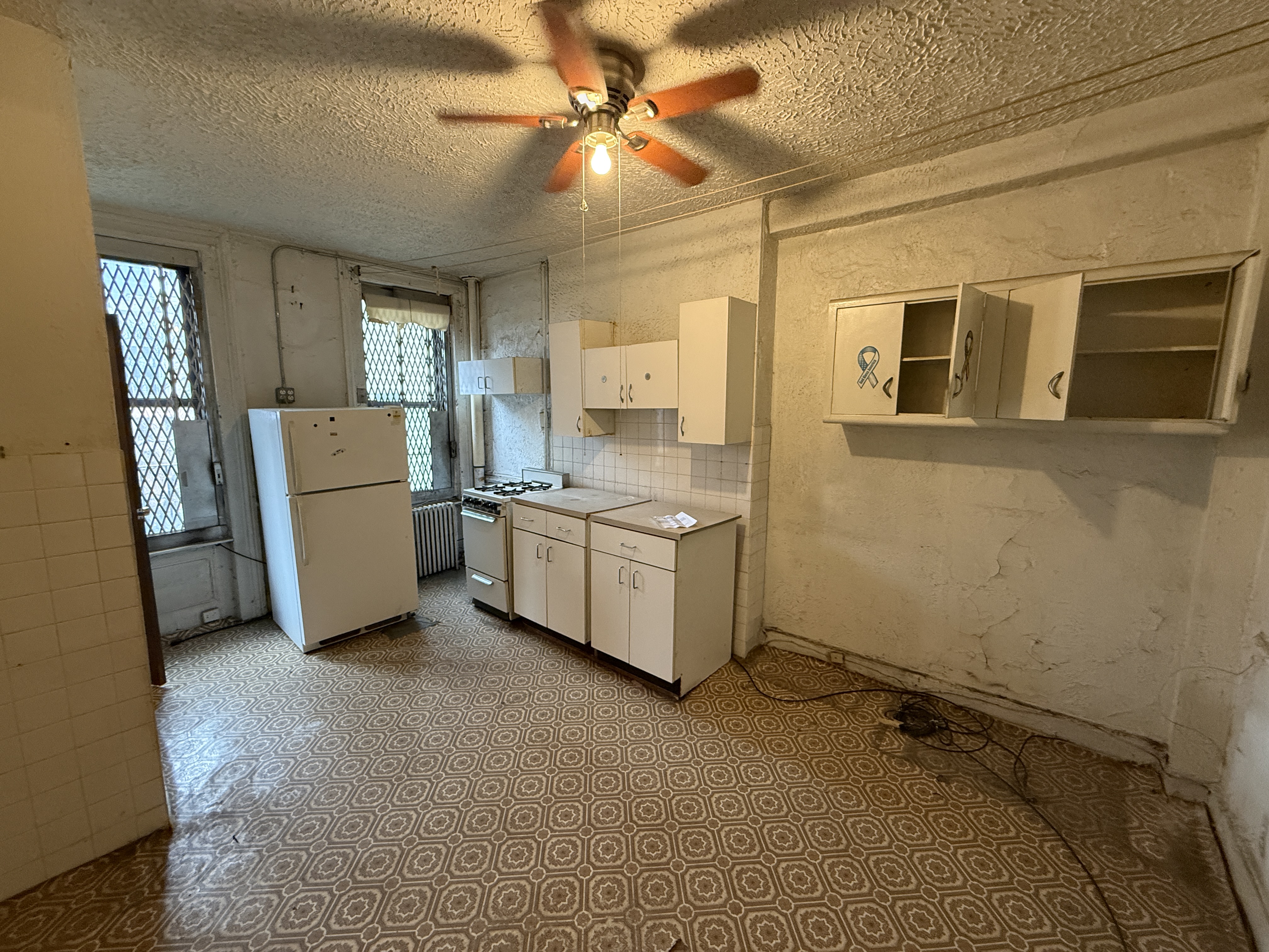 a room with a stove a washer and dryer