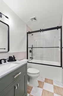a bathroom with a sink a toilet and shower