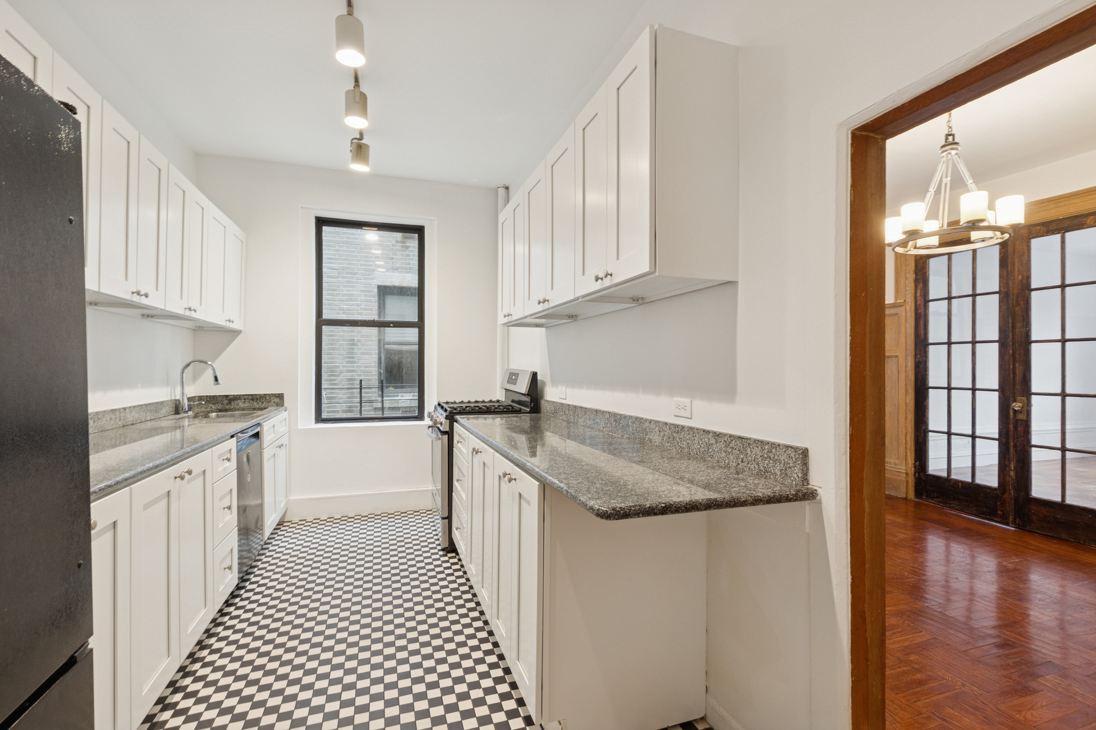 804 West 180th Street, Unit 41 Manhattan, NY 10033 - Photo 11 of 23 a kitchen with granite countertop a sink stove and cabinets