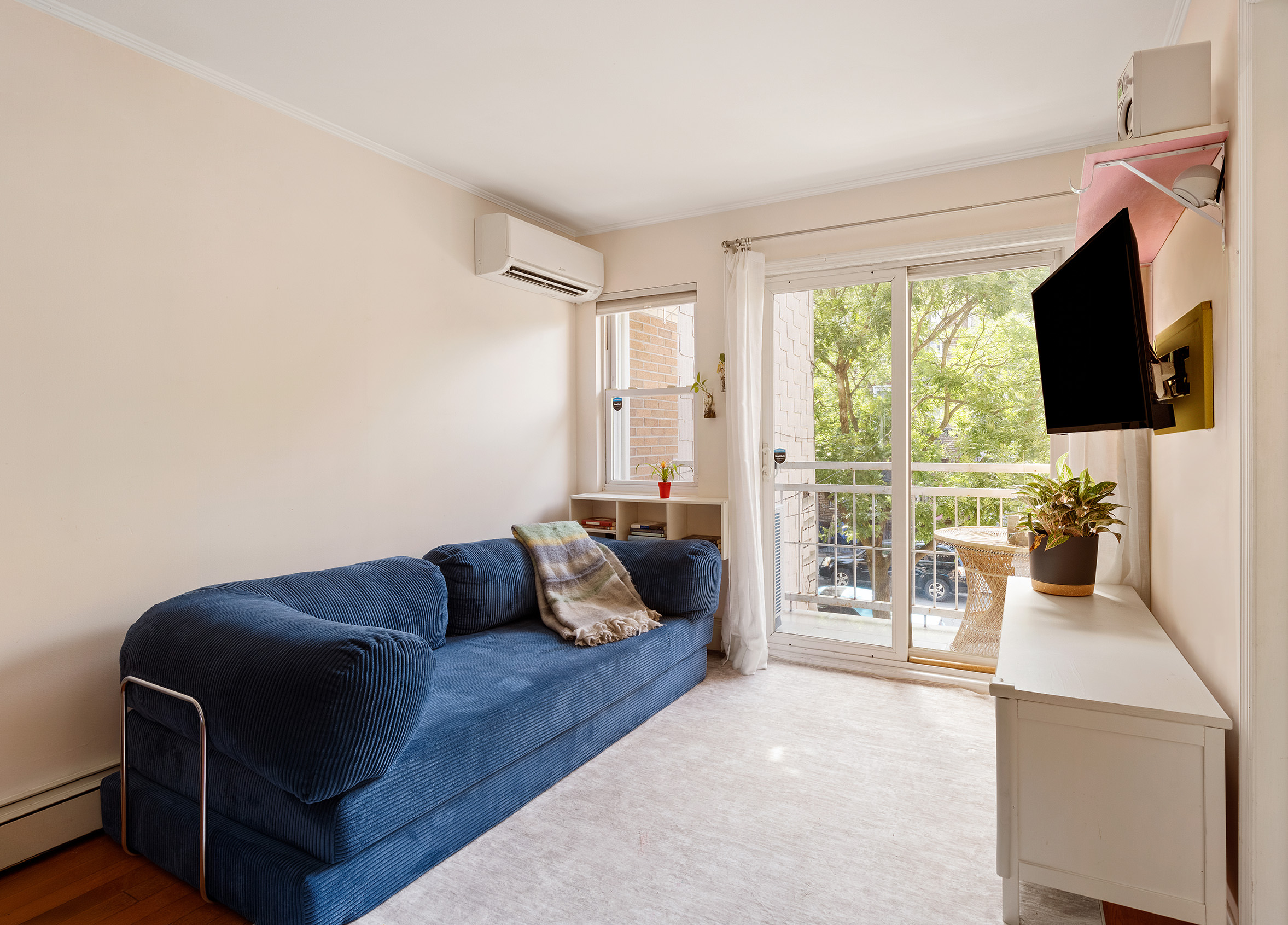 1427 Greene Avenue, Unit 2 Brooklyn, NY 11237 - Photo 2 of 9 a living room with furniture and a flat screen tv