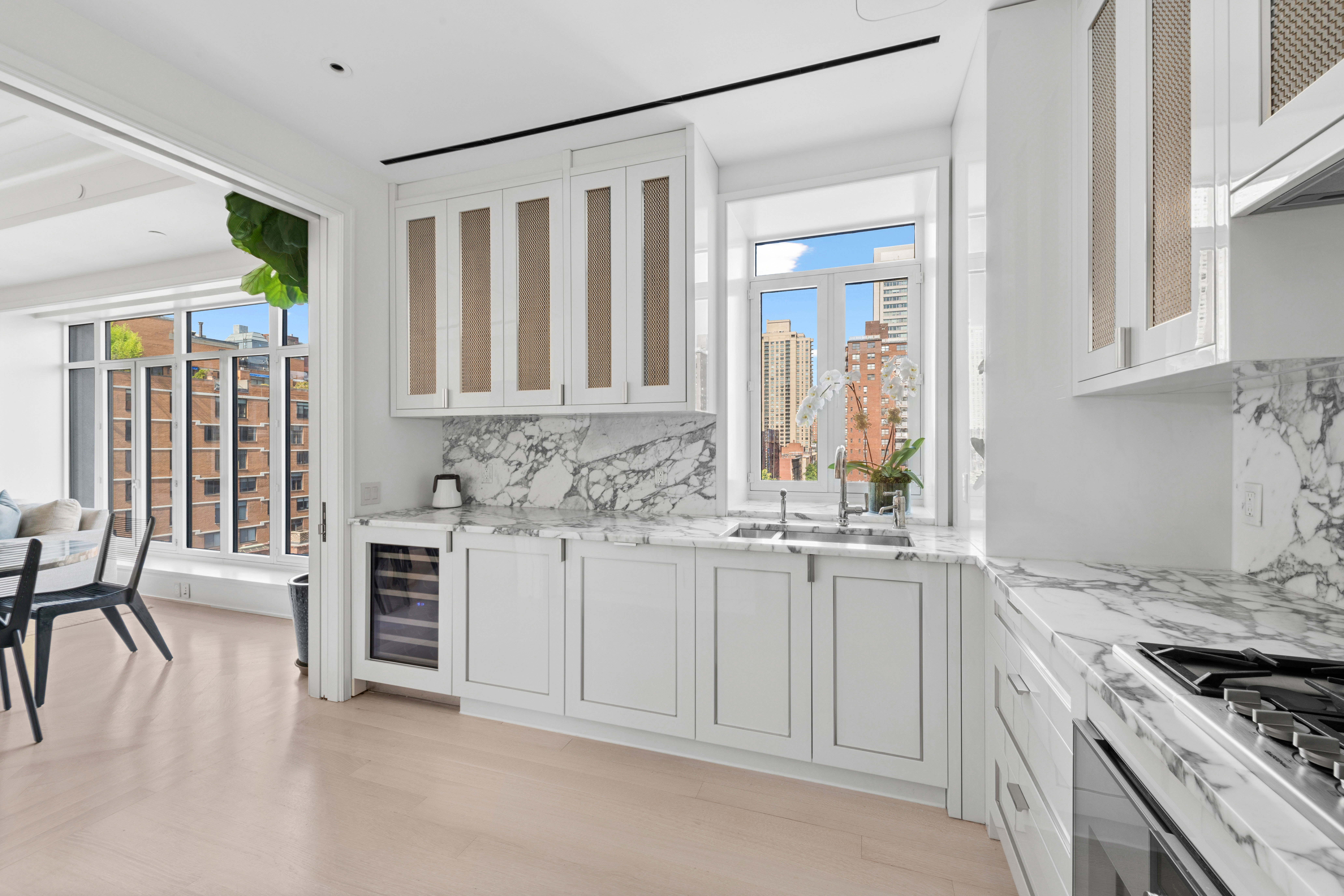 40 East End Avenue, Unit 9B Manhattan, NY 10028 - Photo 3 of 25 a kitchen with granite countertop a sink stove and cabinets