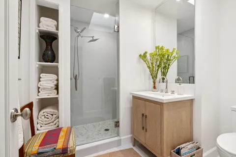 a bathroom with a sink a toilet and shower