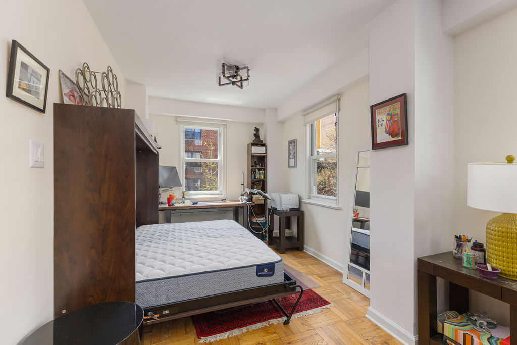 101 West 12th Street, Unit 5V Manhattan, NY 10011 - Photo 15 of 26 a living room with furniture and a flat screen tv