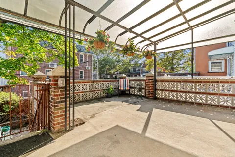 a view of a porch with wooden floor and iron stairs