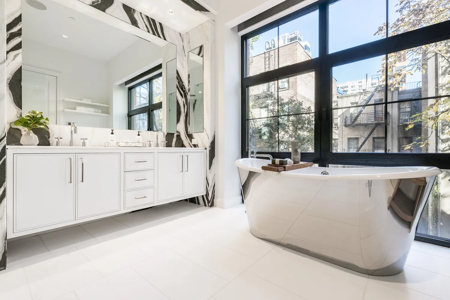 a large white bed sitting in a room next to a window