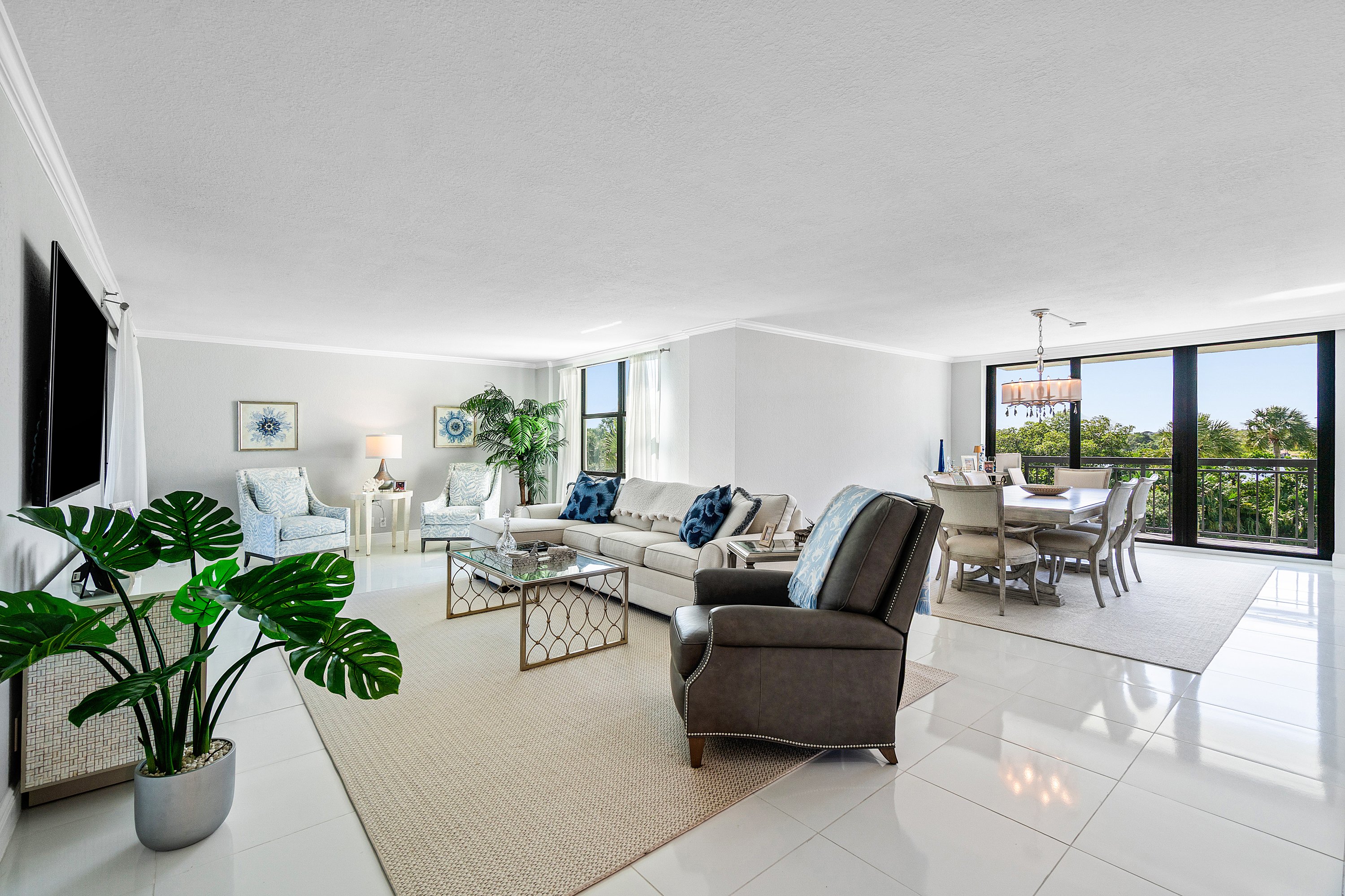 2003 North Ocean Boulevard, Unit 305 Boca Raton, FL 33431 - Photo 7 of 56 a living room with furniture potted plant and a flat screen tv