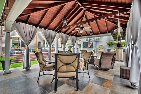 a view of a house with backyard and porch